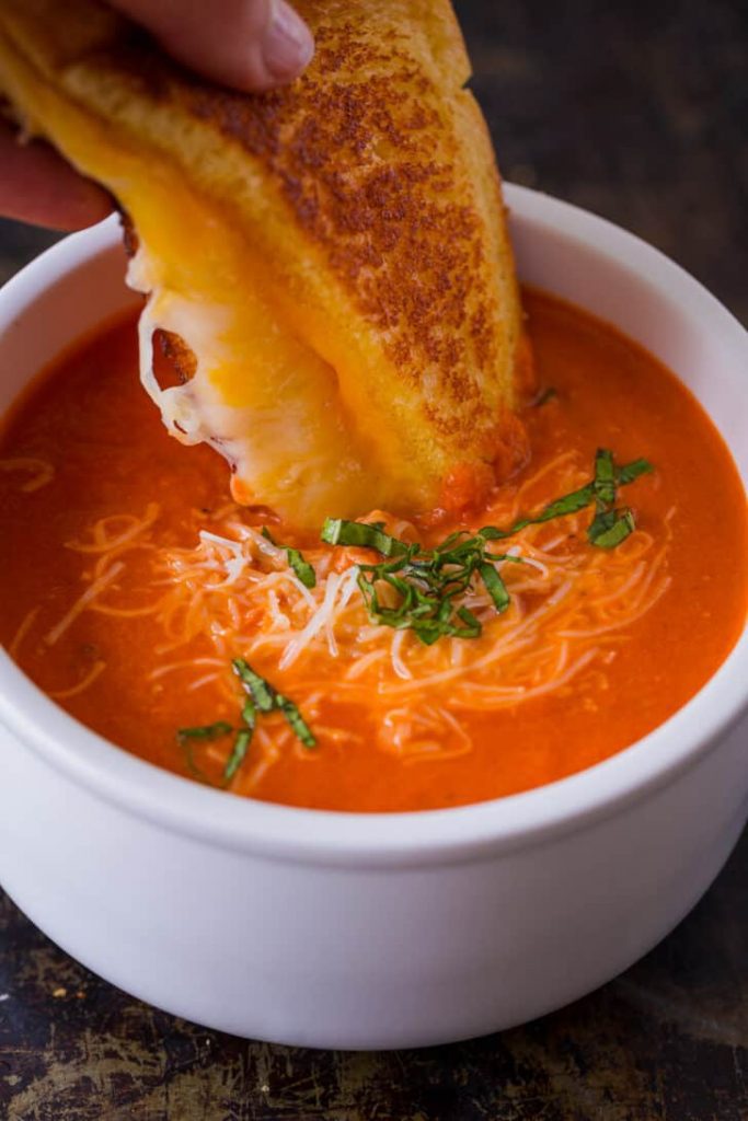 tomato, soup, grilled cheese, comfort food, homemade, classic, lunch, dinner, easy recipe, creamy, crispy, sandwich, cheddar, sourdough, onions, garlic, tomato paste, San Marzano, canned tomatoes, fresh tomatoes, broth, heavy cream, butter, olive oil, immersion blender, quick meal, cozy, family favorite, cheese pull, gooey, toasted, pan-grilled, savory, tangy, smooth, sharp cheddar, rustic bread, melt, garlic powder, Dijon mustard, golden brown, comfort, fall recipe, winter food, nostalgic, childhood favorite, easy cooking, meal prep, soup and sandwich, hearty, rich flavor, indulgent