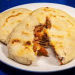 Keywords: pupusas, Salvadoran food, cheese pupusa, pupusas revueltas, masa harina recipe, Chef Ed, curtido slaw, salsa roja, Central American street food, grilled pupusa, gluten-free Latin food, Latin comfort food, pupusas de queso, pork pupusa, authentic pupusas, Loroco filling, homemade tortillas, Salvadoran cuisine, El Salvador recipes, Latin cheese dish, Latin American cuisine, fermented cabbage, healthy Latin meals, corn tortilla pupusa, stuffed masa dough, cheesy Latin snack, meat and cheese pupusa, pupusas tradition, Chef Ed pupusa recipe