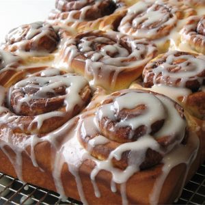 Keywords: cinnamon buns, cinnamon rolls, homemade cinnamon buns, Chef Ed recipe, fluffy rolls, sweet breakfast, brunch recipe, cream cheese glaze, cinnamon sugar, baked goods, fresh rolls, gooey rolls, cinnamon swirl, sweet dough, dessert buns, soft rolls, yeast rolls, baking recipe, cinnamon filling, breakfast treat, pastry recipe, homemade dessert, bakery buns, easy cinnamon rolls, warm cinnamon, breakfast pastry, holiday baking, sticky buns, vanilla glaze, comfort food. 1/2
