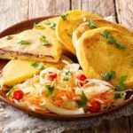 Keywords: pupusas, Salvadoran food, cheese pupusa, pupusas revueltas, masa harina recipe, Chef Ed, curtido slaw, salsa roja, Central American street food, grilled pupusa, gluten-free Latin food, Latin comfort food, pupusas de queso, pork pupusa, authentic pupusas, Loroco filling, homemade tortillas, Salvadoran cuisine, El Salvador recipes, Latin cheese dish, Latin American cuisine, fermented cabbage, healthy Latin meals, corn tortilla pupusa, stuffed masa dough, cheesy Latin snack, meat and cheese pupusa, pupusas tradition, Chef Ed pupusa recipe