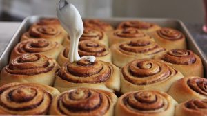 Keywords: cinnamon buns, cinnamon rolls, homemade cinnamon buns, Chef Ed recipe, fluffy rolls, sweet breakfast, brunch recipe, cream cheese glaze, cinnamon sugar, baked goods, fresh rolls, gooey rolls, cinnamon swirl, sweet dough, dessert buns, soft rolls, yeast rolls, baking recipe, cinnamon filling, breakfast treat, pastry recipe, homemade dessert, bakery buns, easy cinnamon rolls, warm cinnamon, breakfast pastry, holiday baking, sticky buns, vanilla glaze, comfort food. 1/2