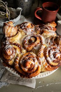 Keywords: cinnamon buns, cinnamon rolls, homemade cinnamon buns, Chef Ed recipe, fluffy rolls, sweet breakfast, brunch recipe, cream cheese glaze, cinnamon sugar, baked goods, fresh rolls, gooey rolls, cinnamon swirl, sweet dough, dessert buns, soft rolls, yeast rolls, baking recipe, cinnamon filling, breakfast treat, pastry recipe, homemade dessert, bakery buns, easy cinnamon rolls, warm cinnamon, breakfast pastry, holiday baking, sticky buns, vanilla glaze, comfort food. 1/2